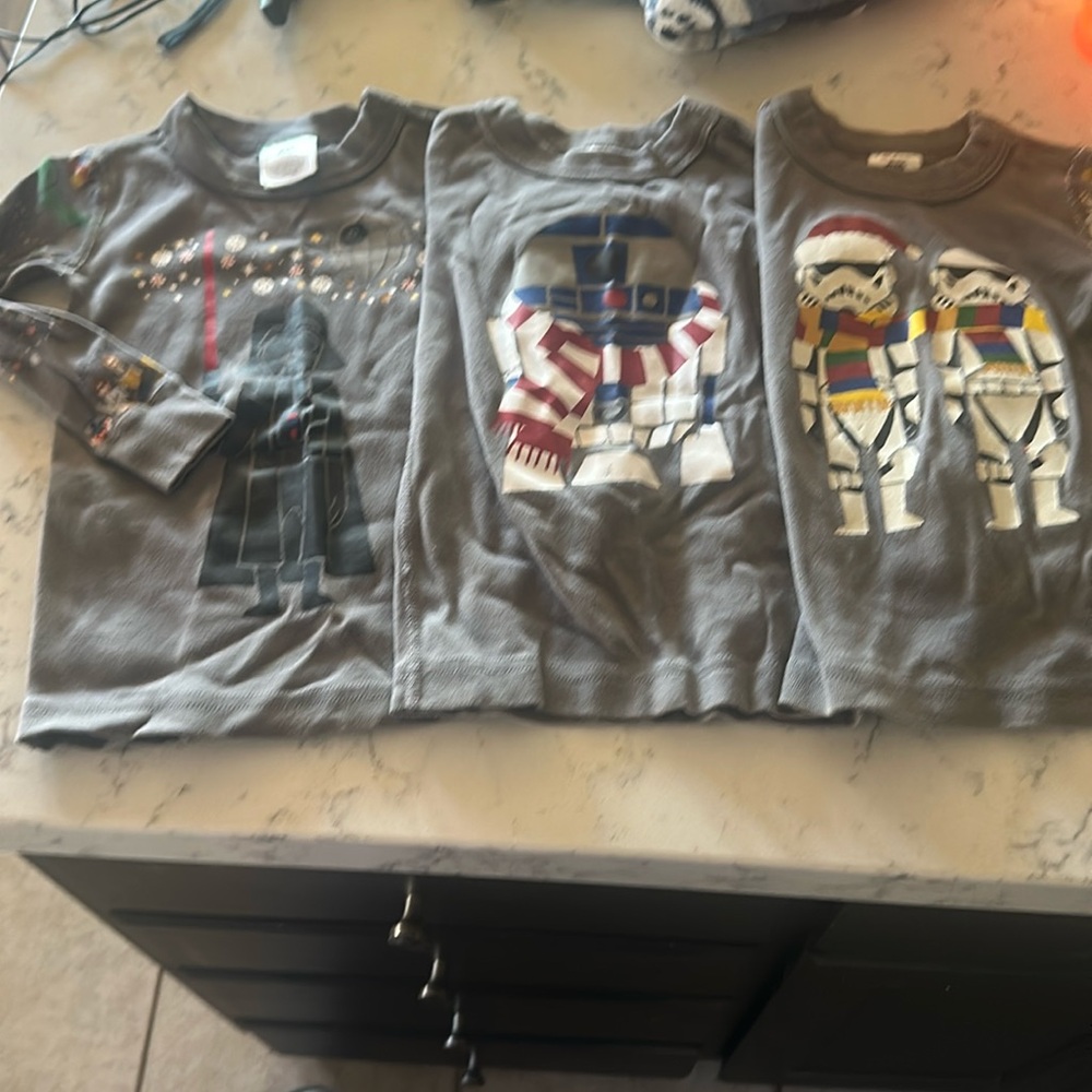 Three Christmas Star Wars shirts.